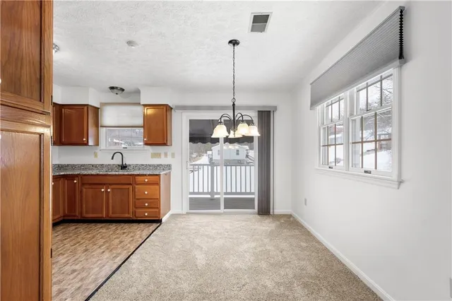 a spacious bathroom with a granite countertop sink a mirror a bathtub and window