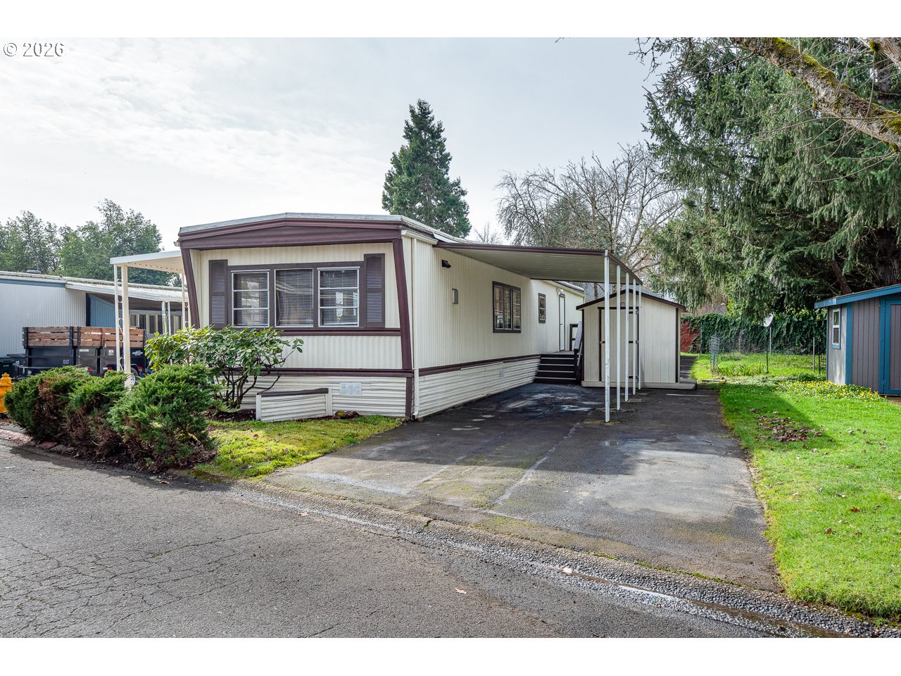 1475 Green Acres Road, Unit 172 Eugene, OR 97408 - Photo 1 of 20 a view of a house with backyard and trees