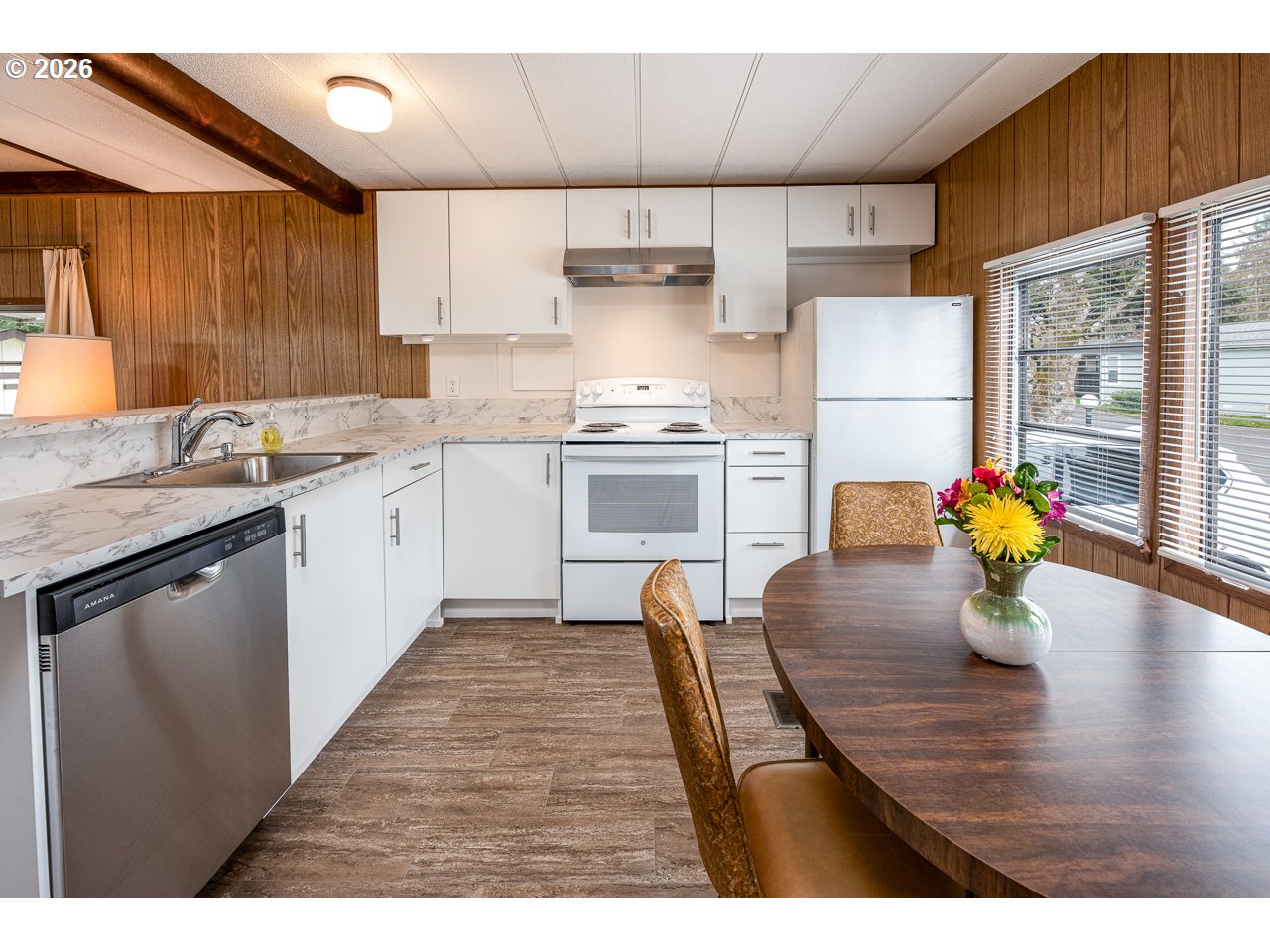 1475 Green Acres Road, Unit 172 Eugene, OR 97408 - Photo 12 of 20 a kitchen with stainless steel appliances granite countertop a stove a sink dishwasher and a refrigerator
