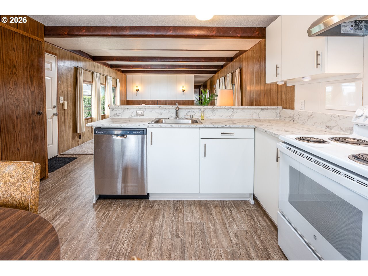 1475 Green Acres Road, Unit 172 Eugene, OR 97408 - Photo 13 of 20 a kitchen with a sink a stove cabinets and wooden floor