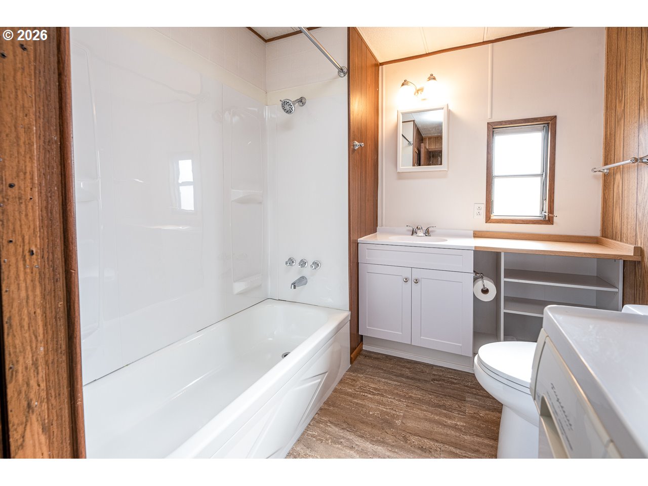 1475 Green Acres Road, Unit 172 Eugene, OR 97408 - Photo 19 of 20 a bathroom with a bathtub shower sink vanity and toilet