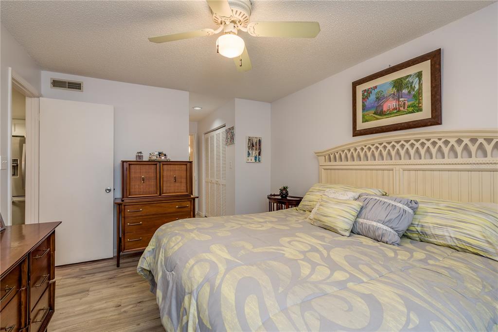 1901 Lennox Road East, Unit 1901 Palm Harbor, FL 34683 - Photo 12 of 25 a bedroom with a bed and a chandelier