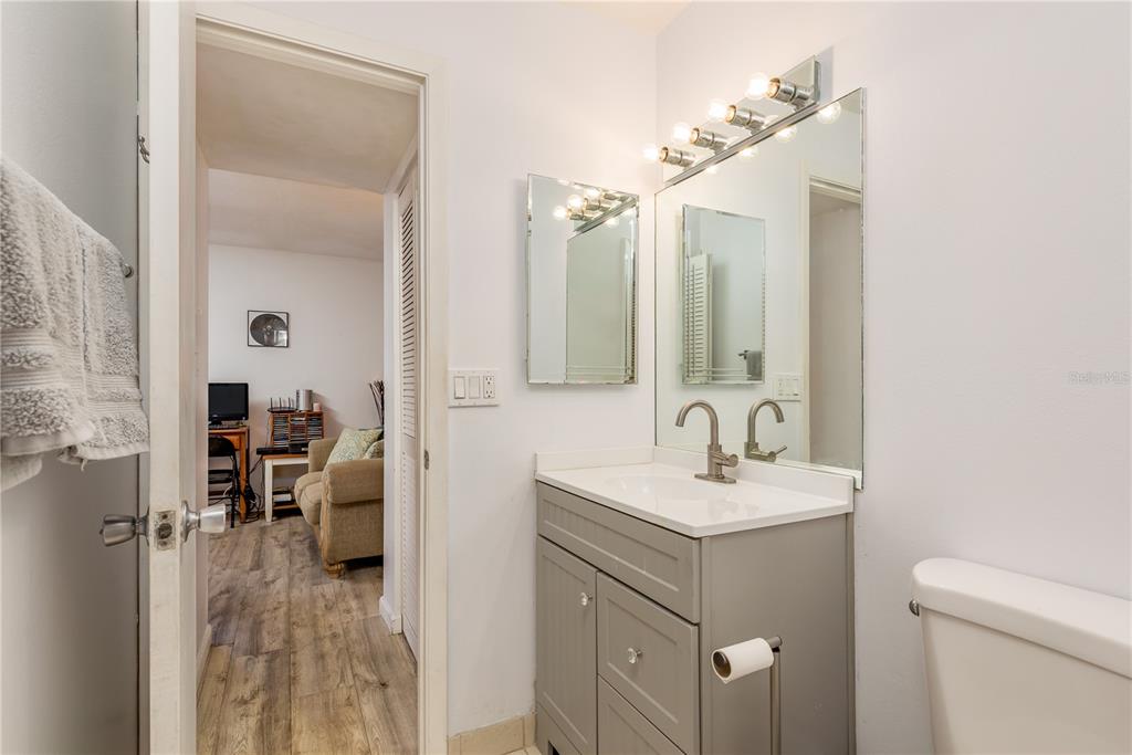 1901 Lennox Road East, Unit 1901 Palm Harbor, FL 34683 - Photo 16 of 25 a en suite bathroom with a sink vanity and a mirror