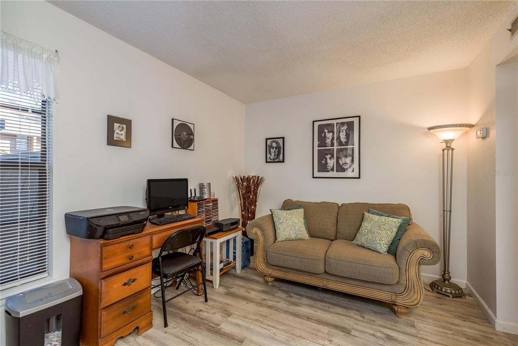 1901 Lennox Road East, Unit 1901 Palm Harbor, FL 34683 - Photo 18 of 25 a living room with furniture and a flat screen tv