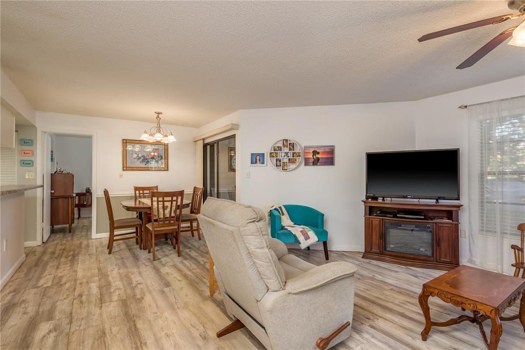 1901 Lennox Road East, Unit 1901 Palm Harbor, FL 34683 - Photo 3 of 25 a living room with furniture and a flat screen tv