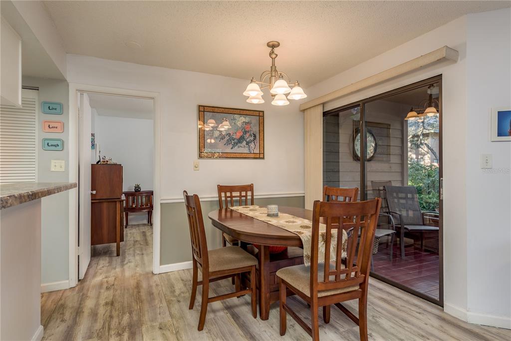 1901 Lennox Road East, Unit 1901 Palm Harbor, FL 34683 - Photo 6 of 25 a view of a dining room with furniture window and wooden floor
