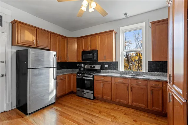 a kitchen with stainless steel appliances granite countertop a refrigerator sink and cabinets