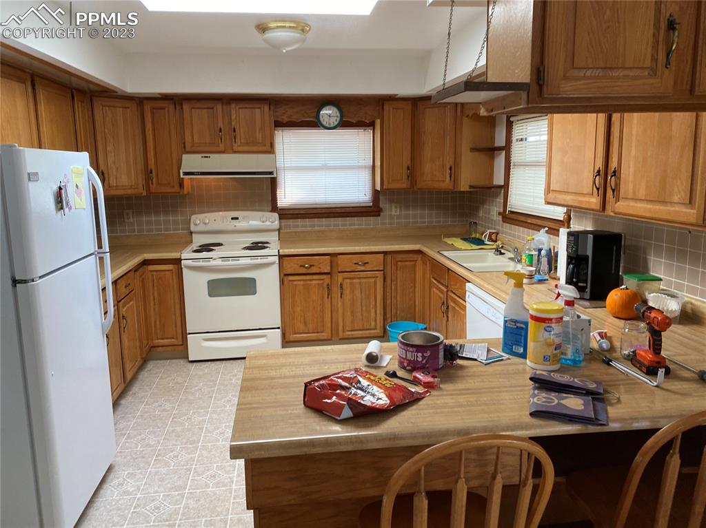 2150 Glenn Street Colorado Springs, CO 80904 - Photo 17 of 30 a kitchen with stainless steel appliances granite countertop a sink refrigerator stove and microwave