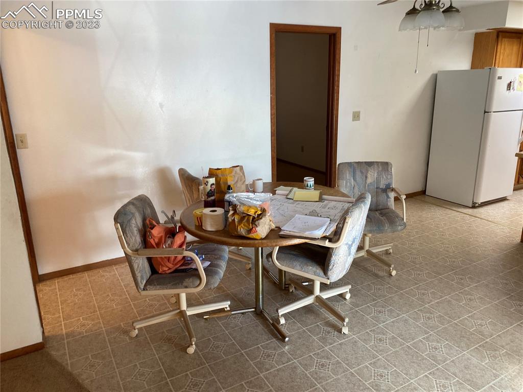 2150 Glenn Street Colorado Springs, CO 80904 - Photo 19 of 30 a dining room with furniture and a refrigerator