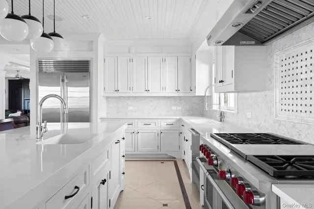 a open dining room with white cabinets and white appliances