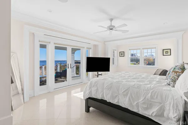 a spacious bathroom with double vanity a sink a mirror a bathtub and next to a window
