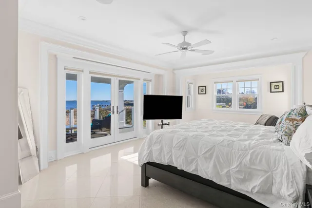 a spacious bathroom with double vanity a sink a mirror a bathtub and next to a window