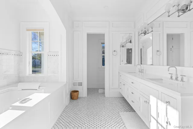 a bathroom with a sink a toilet and a mirror