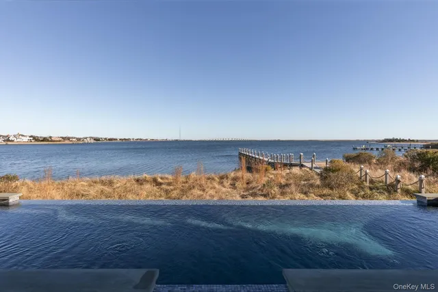 a living room with furniture and large windows