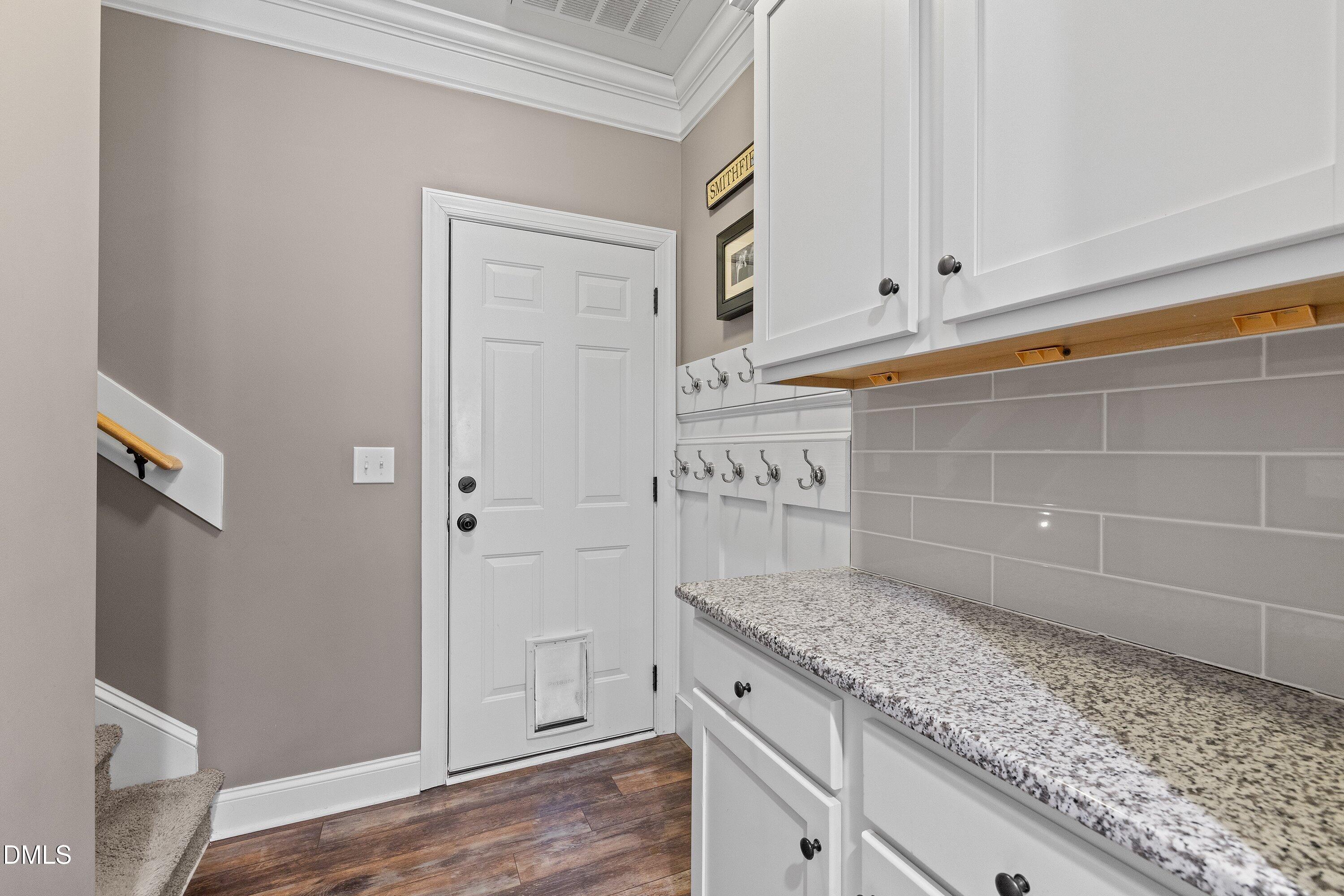 59 Coats Ridge Drive Benson, NC 27504 - Photo 11 of 44 a kitchen with granite countertop white cabinets and a wooden floor