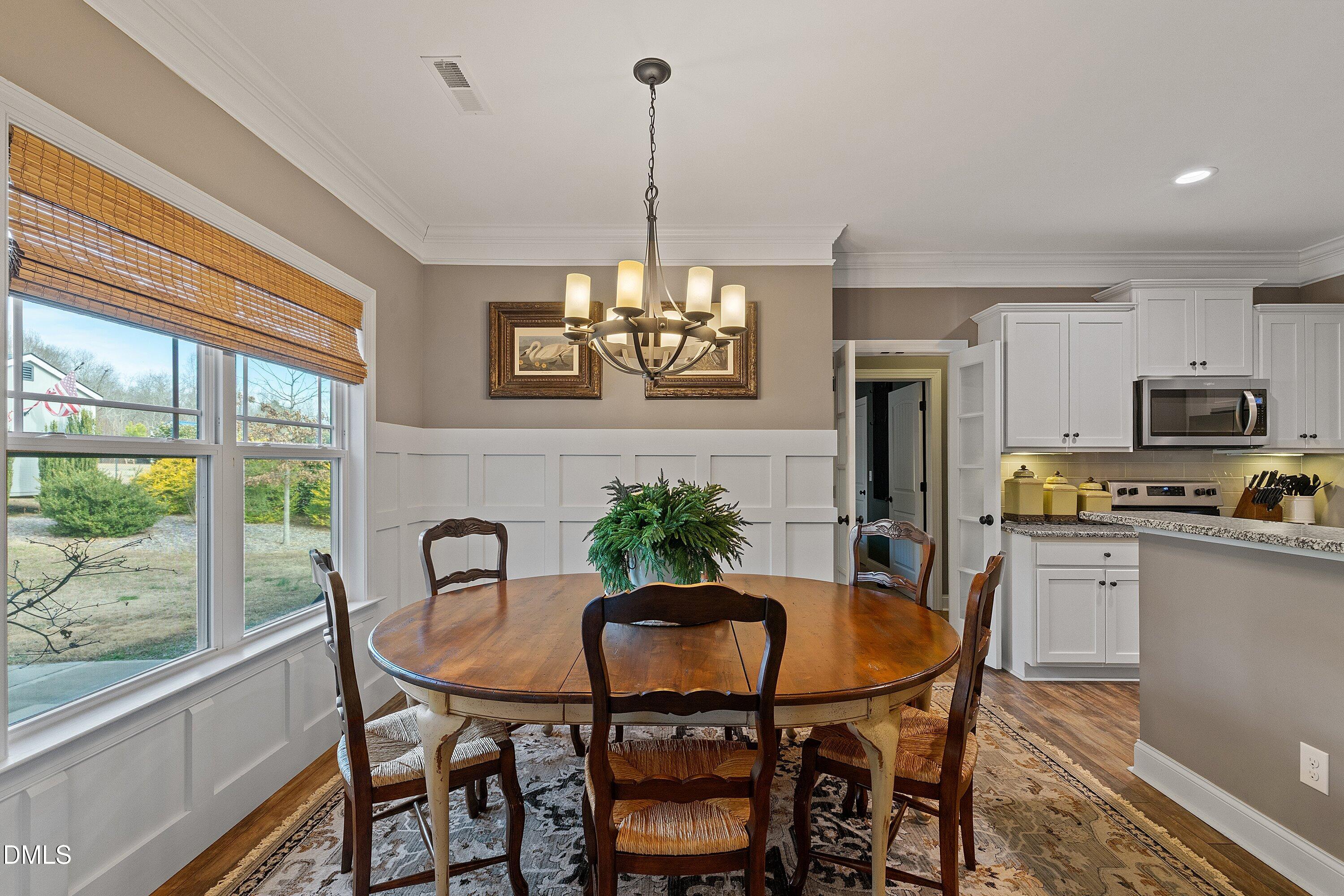 59 Coats Ridge Drive Benson, NC 27504 - Photo 13 of 44 a dining room with furniture a chandelier and window