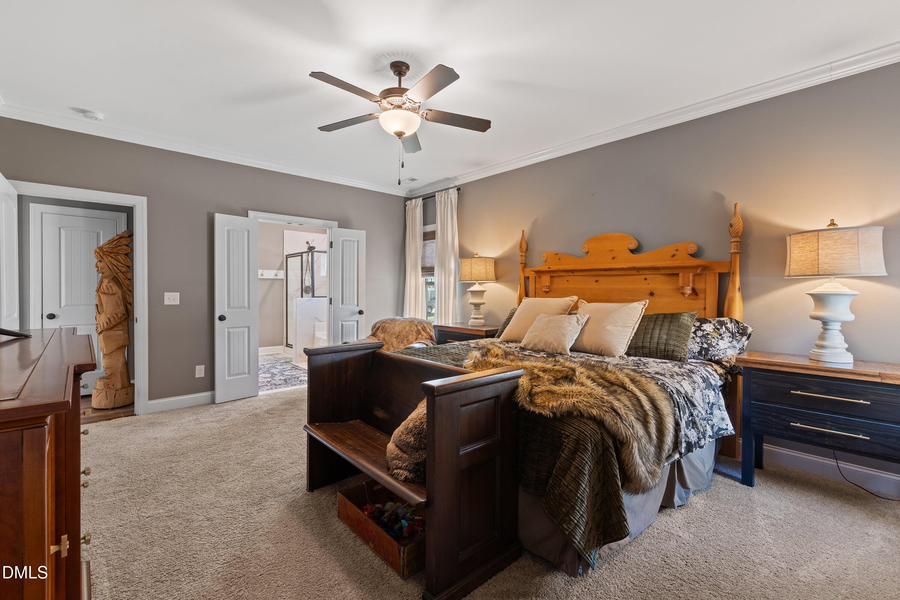 59 Coats Ridge Drive Benson, NC 27504 - Photo 17 of 44 a bed room with a bed and a chandelier