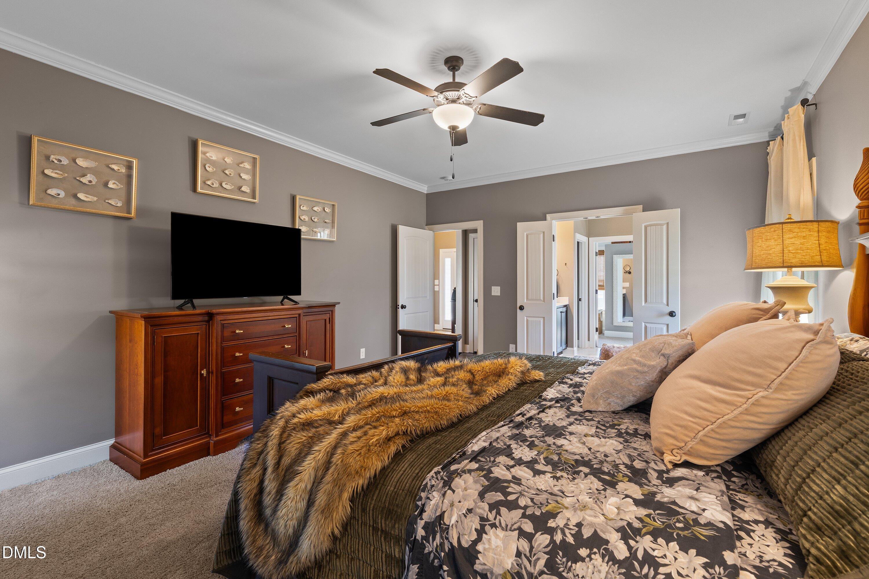 59 Coats Ridge Drive Benson, NC 27504 - Photo 18 of 44 a bedroom with a bed and a flat screen tv