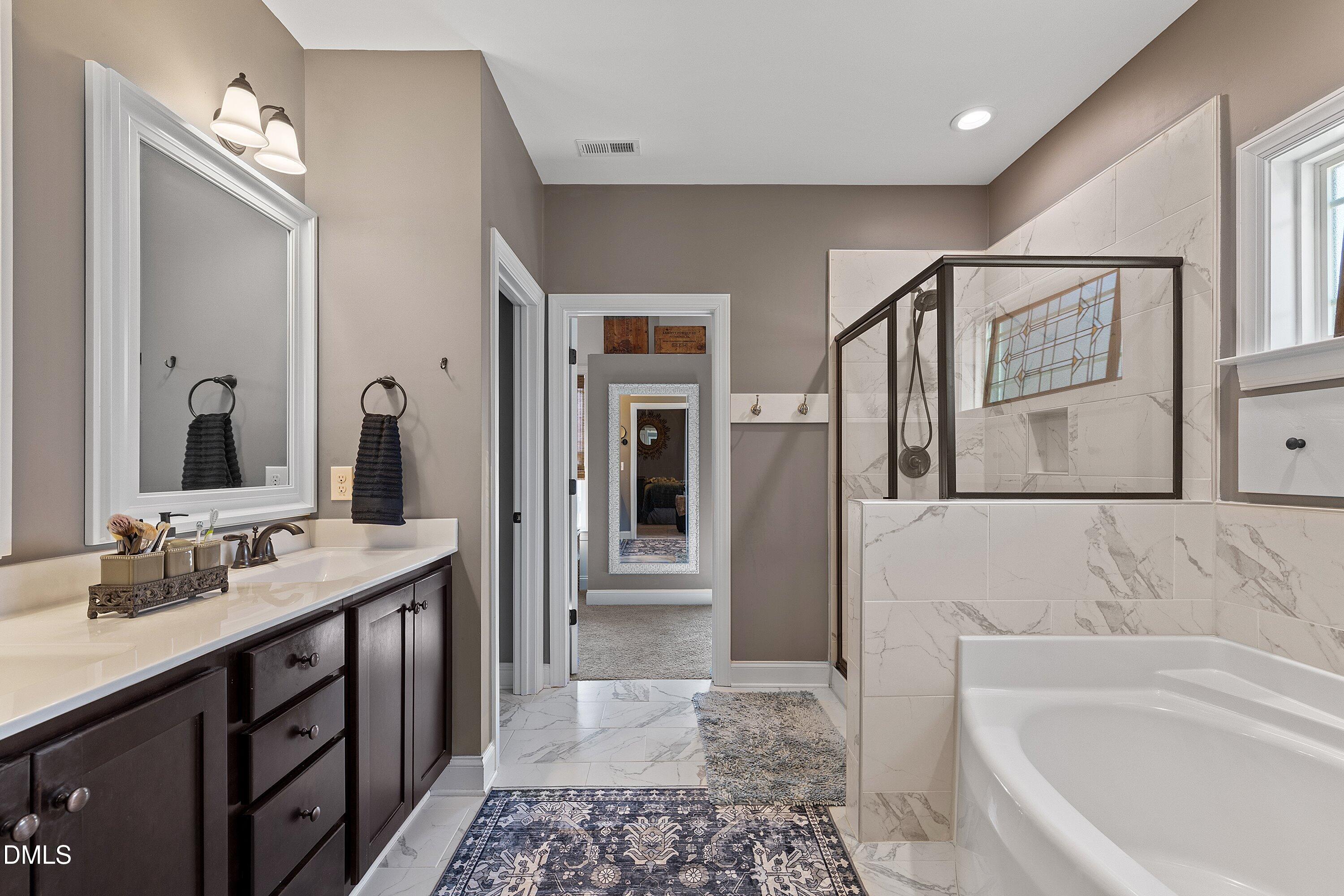 59 Coats Ridge Drive Benson, NC 27504 - Photo 19 of 44 a bathroom with a tub sink and mirror