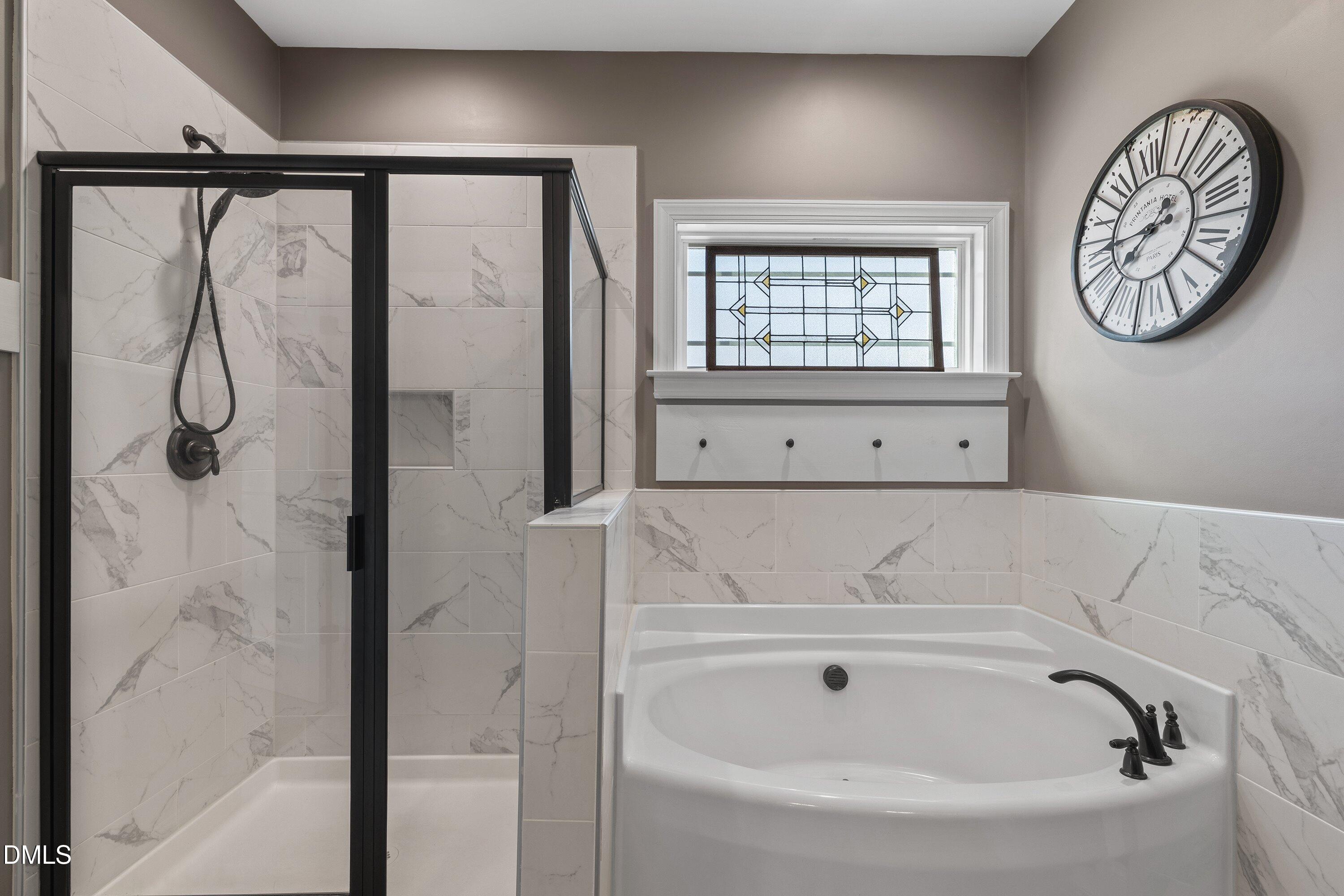 59 Coats Ridge Drive Benson, NC 27504 - Photo 21 of 44 a bathroom with a bathtub and a window