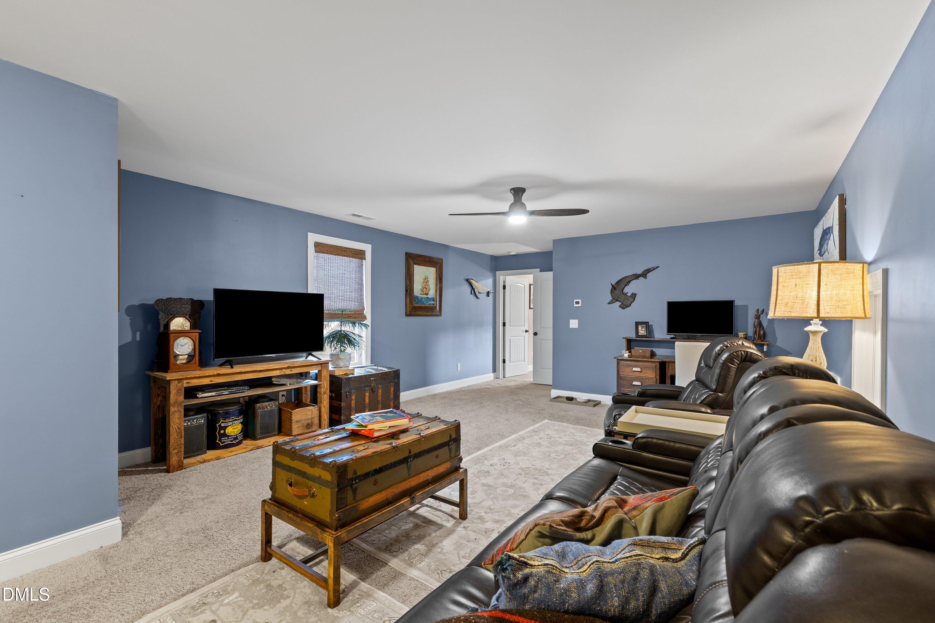 59 Coats Ridge Drive Benson, NC 27504 - Photo 29 of 44 a living room with furniture and a flat screen tv