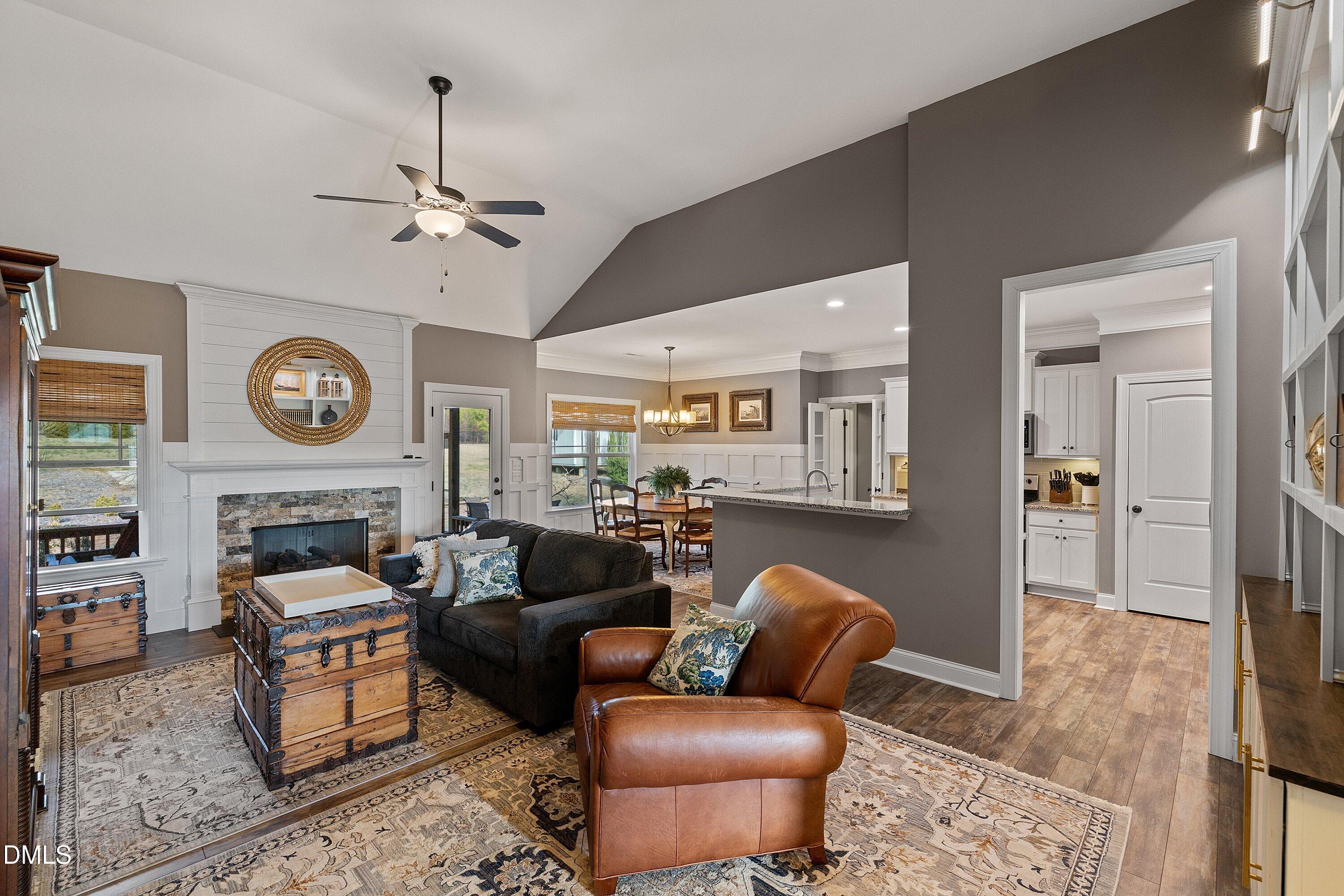 59 Coats Ridge Drive Benson, NC 27504 - Photo 2 of 44 a living room with furniture a clock on wall and a table