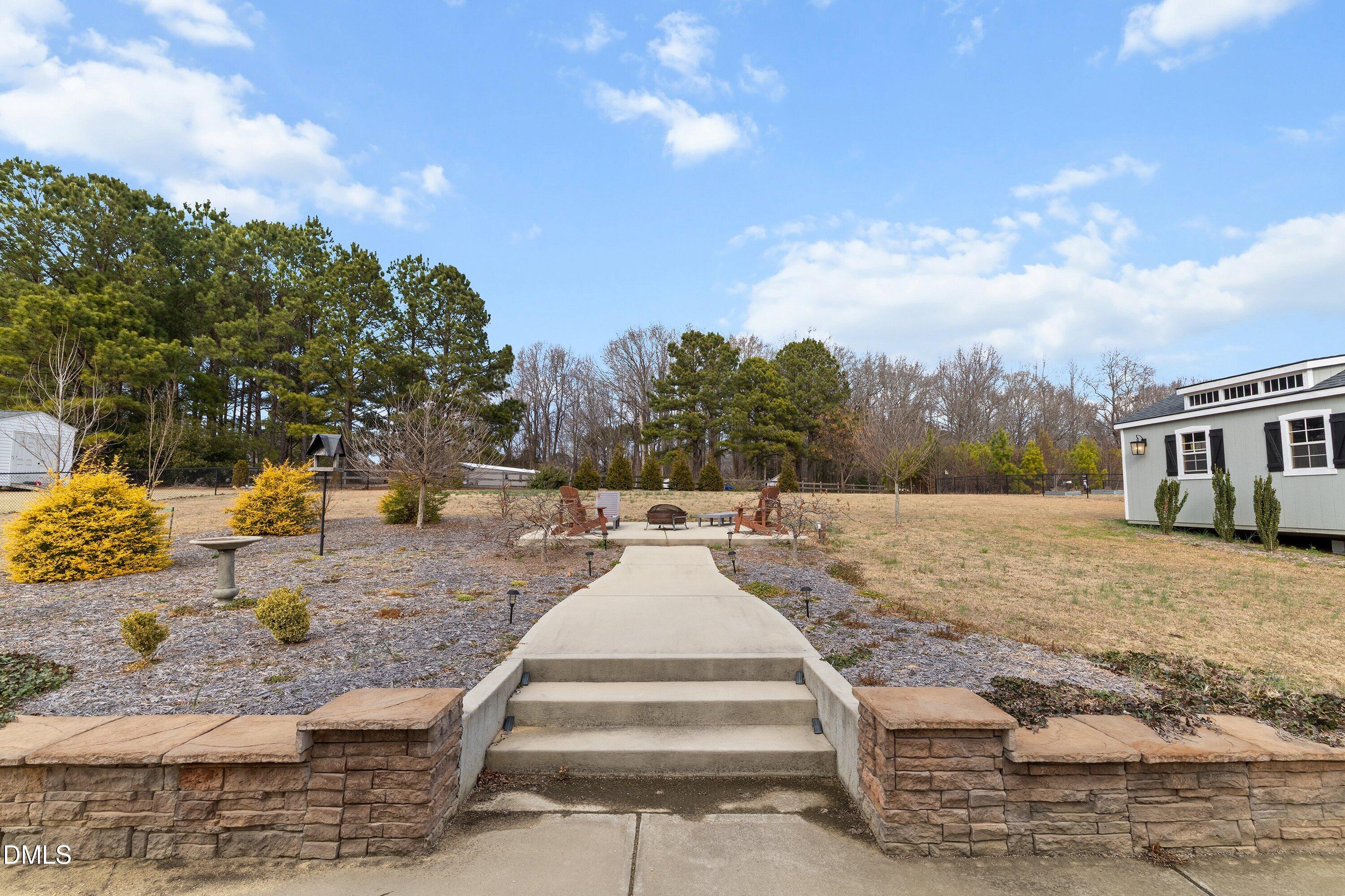 59 Coats Ridge Drive Benson, NC 27504 - Photo 34 of 44 a view of a white house with a yard