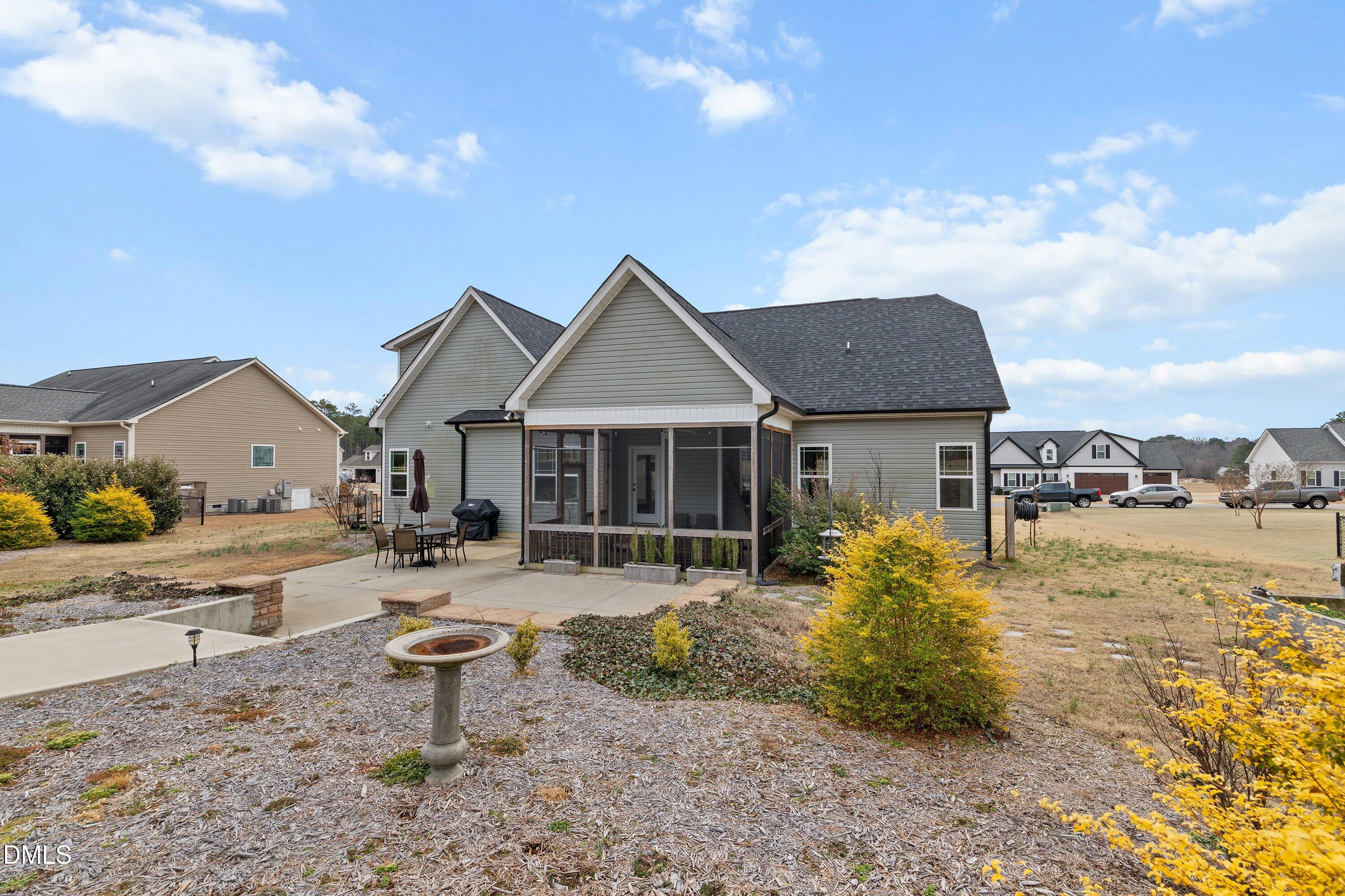 59 Coats Ridge Drive Benson, NC 27504 - Photo 40 of 44 a front view of a house with a yard and lake view