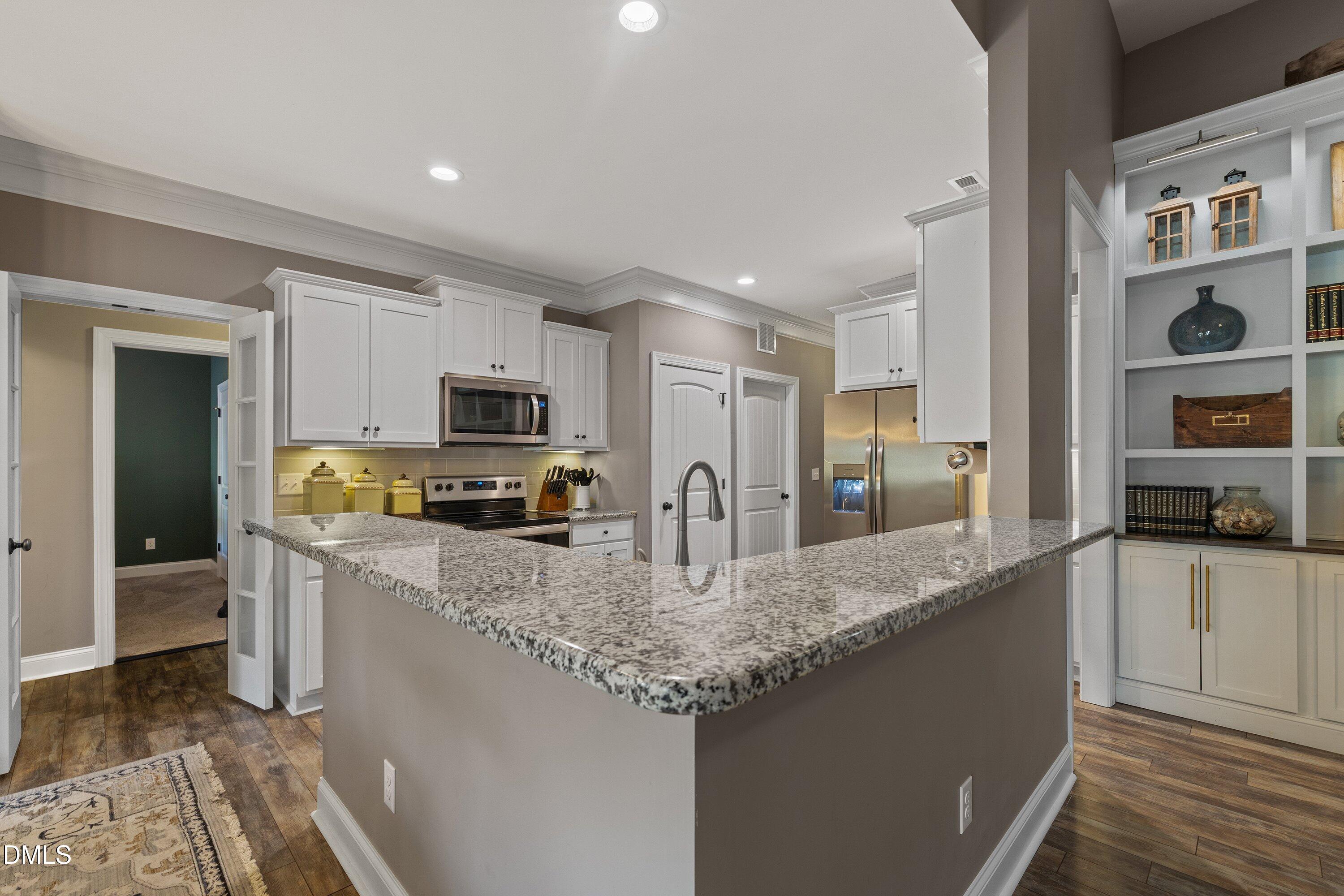 59 Coats Ridge Drive Benson, NC 27504 - Photo 7 of 44 a kitchen with granite countertop a sink counter top space stainless steel appliances and cabinets