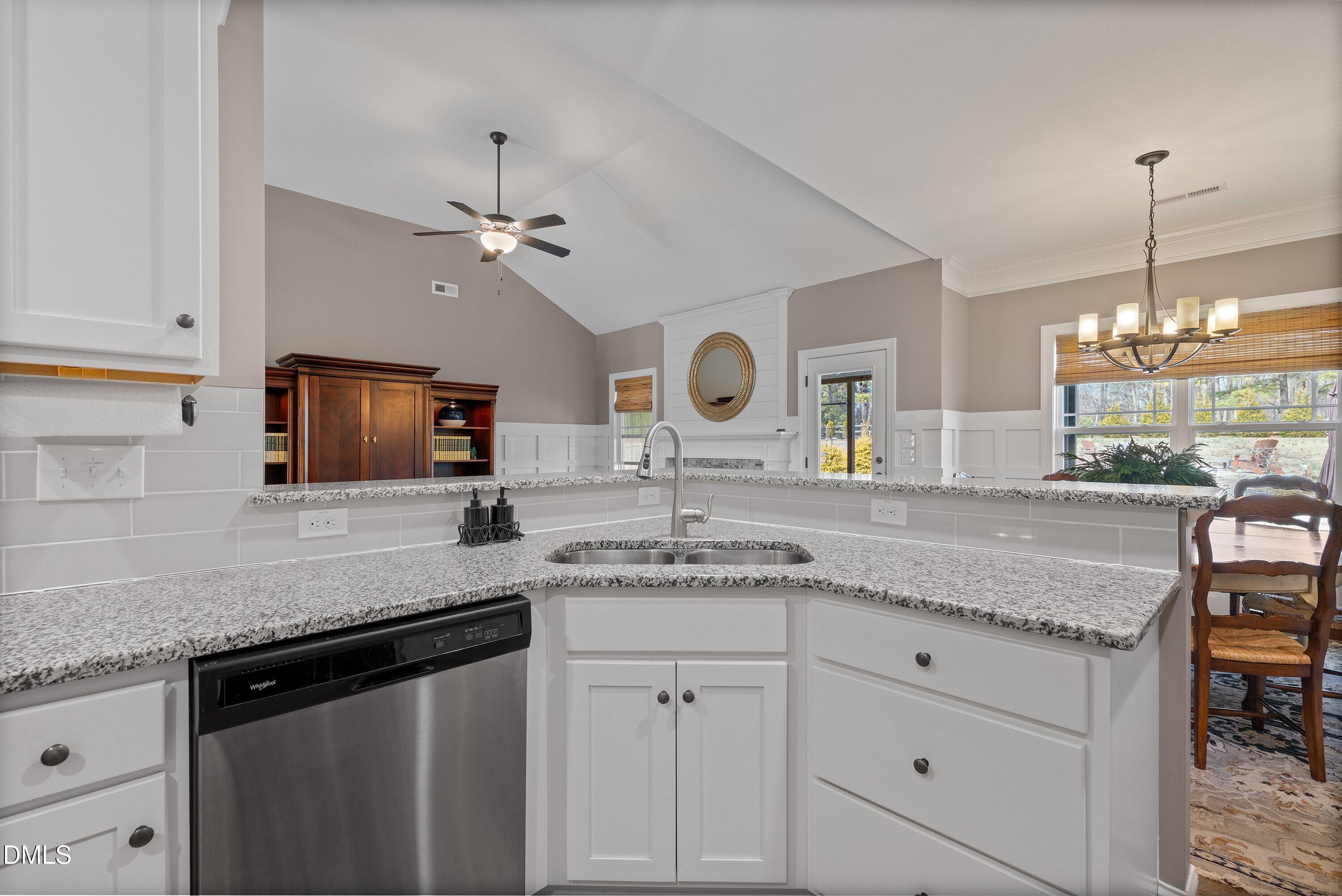59 Coats Ridge Drive Benson, NC 27504 - Photo 8 of 44 a kitchen with granite countertop a sink stainless steel appliances white cabinets and a granite counter tops