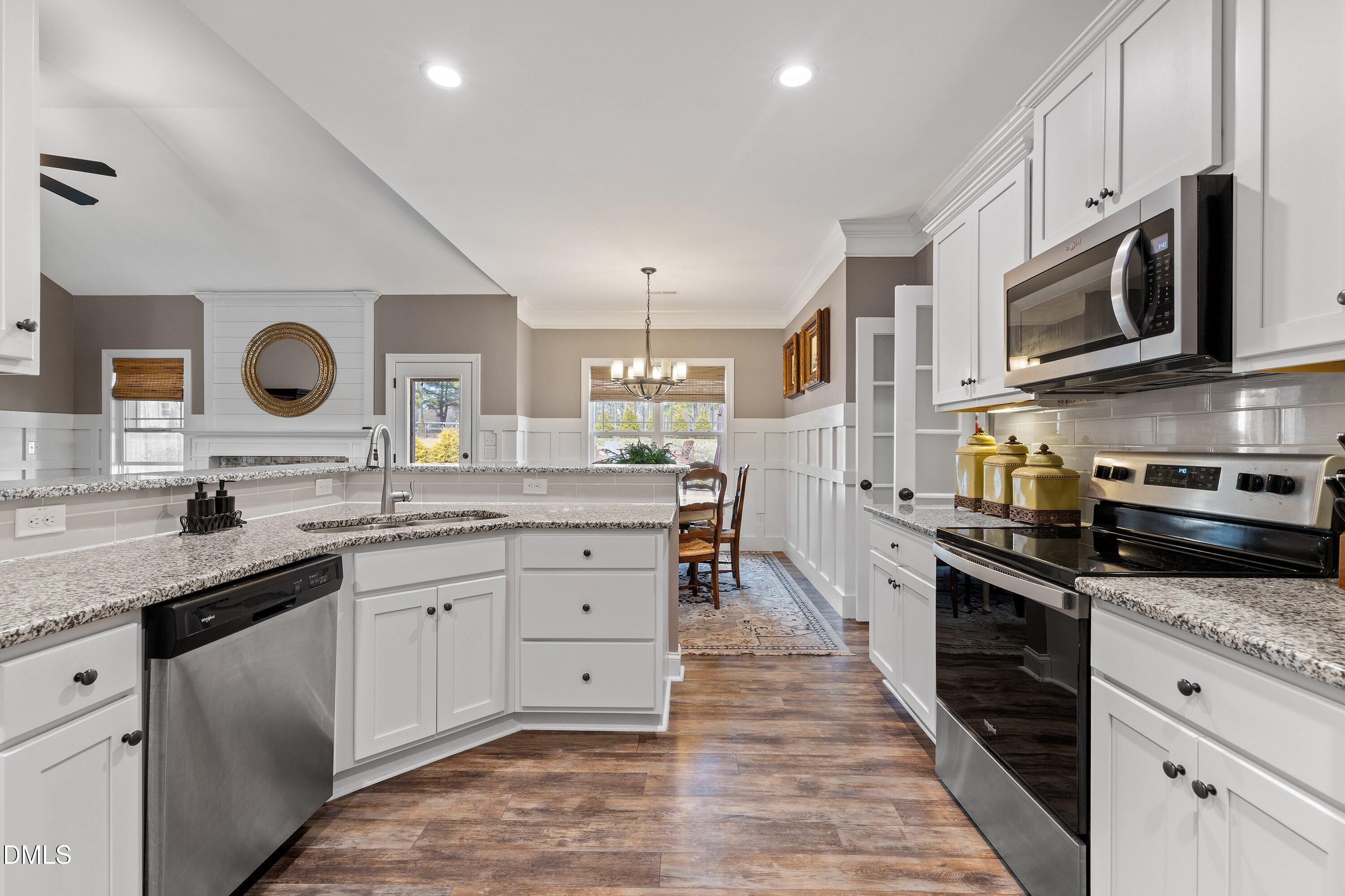 59 Coats Ridge Drive Benson, NC 27504 - Photo 9 of 44 a large kitchen with stainless steel appliances granite countertop a lot of counter space and wooden cabinets