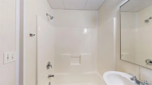 a bathroom with a sink and shower