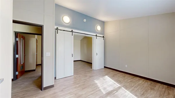a view of hallway with wooden floor