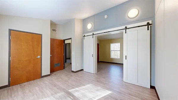 a view of a room with wooden floor and window