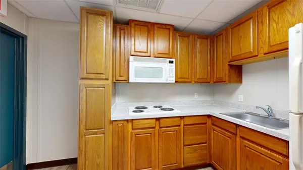 a kitchen with stainless steel appliances granite countertop wooden cabinets a sink and dishwasher