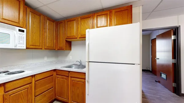 a white refrigerator freezer sitting in a kitchen