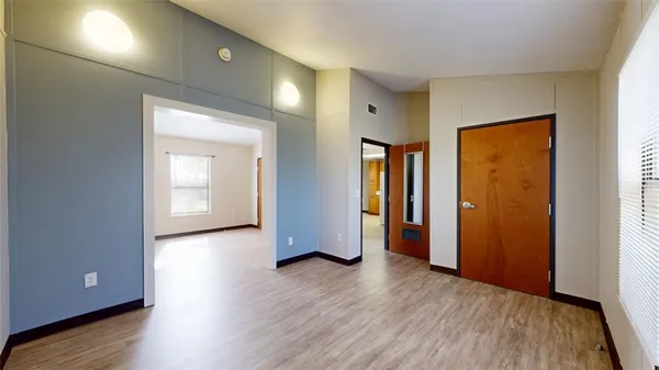an empty room with wooden floor and closet