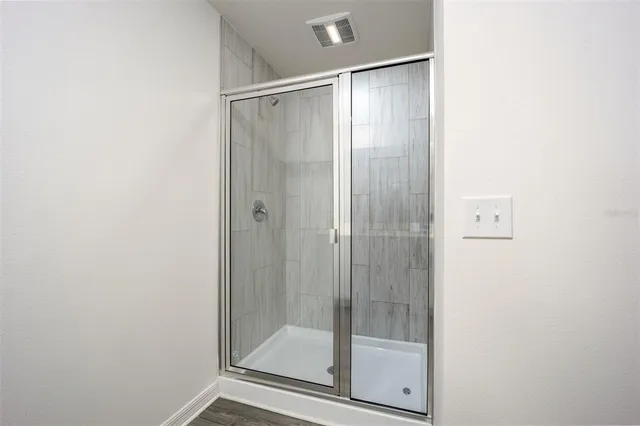 a bathroom with a glass shower door