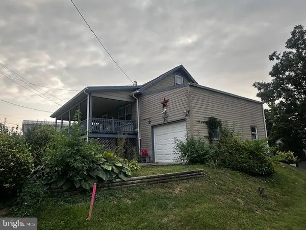 a front view of a house with plants