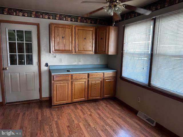303 16th Street Saxton, PA 16678 - Photo 19 of 44 a kitchen with wooden floors and white cabinets