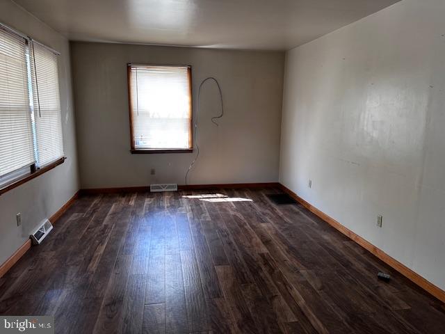 303 16th Street Saxton, PA 16678 - Photo 22 of 44 an empty room with wooden floor and windows