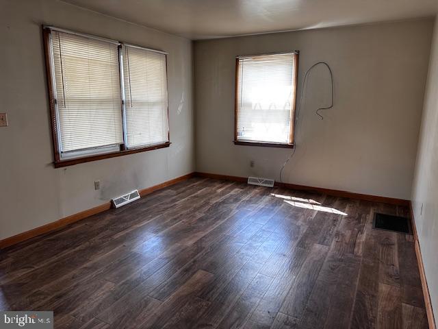 303 16th Street Saxton, PA 16678 - Photo 23 of 44 an empty room with wooden floor and windows
