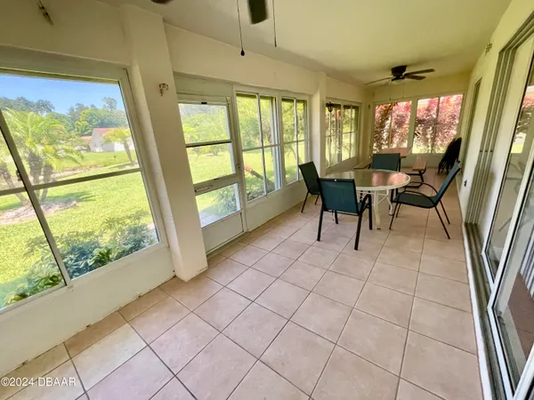 a view of a dining room with furniture large windows and wooden floor