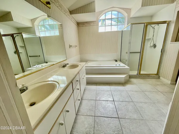 a bathroom with a sink a toilet and a shower