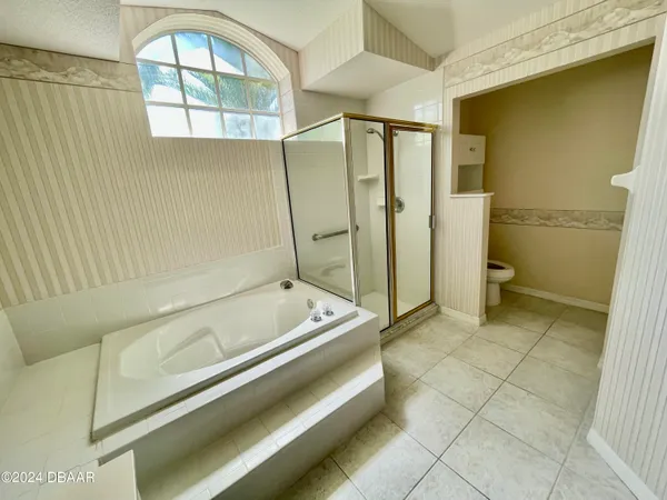 a bathroom with a tub and a shower