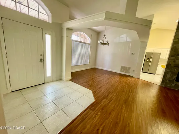 a view of a room with wooden floor and a bathroom