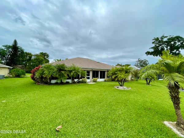 a view of a garden with a building in the background