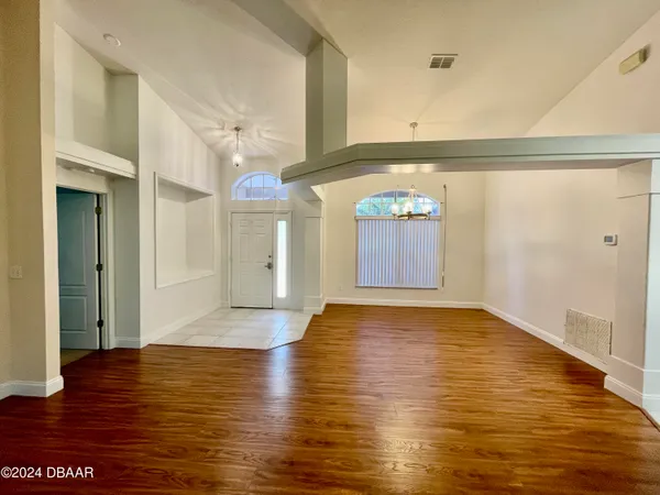 a view of a room with wooden floor and window