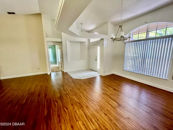 an empty room with wooden floor
