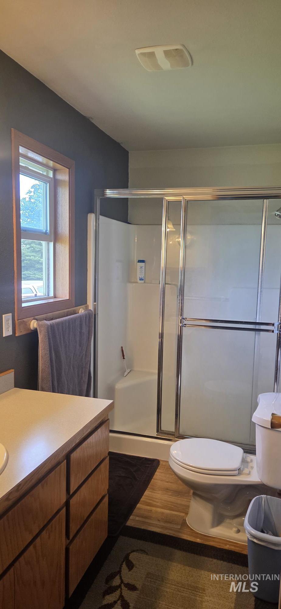 394 Substation Road Cottonwood, ID 83522 - Photo 21 of 37 Window with wood trim, ceiling fan light fixture, recessed ceiling light, and carpet flooring